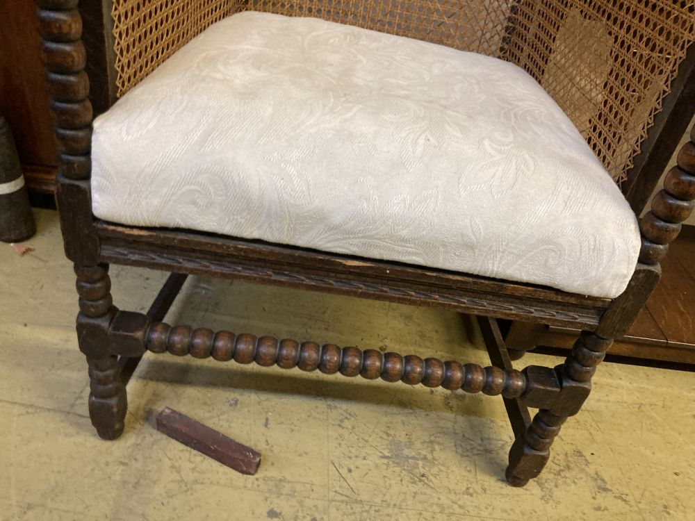 A 1920s oak bergere armchair